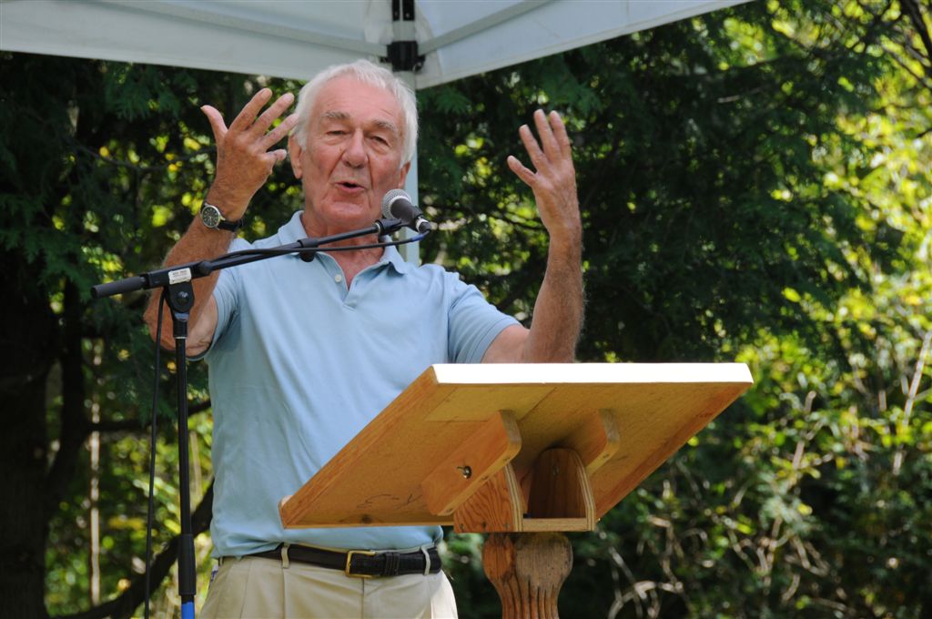 A writer at a podium giving a reading at the Eden Mills Writers' Festival